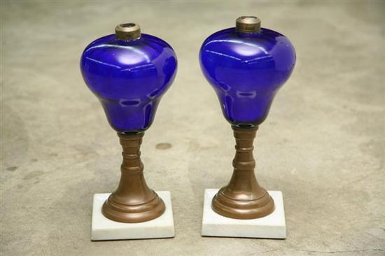 Appraisal: TWO MATCHING OIL LAMPS With bright blue glass fonts and