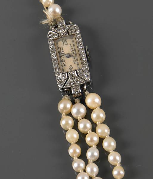 Appraisal: A diamond and platinum wrist watch with added cultured pearl