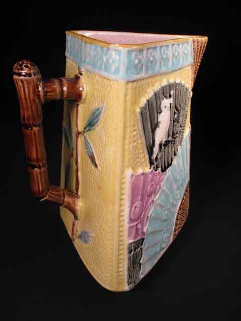 Appraisal: Majolica pottery pitcher with three-corner shape fan design and lavender