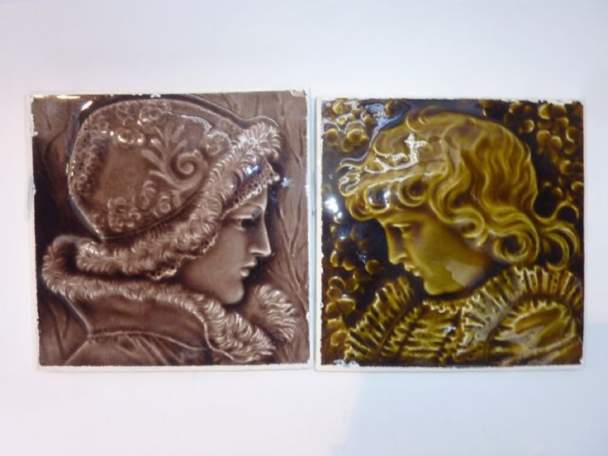 Appraisal: A pair of th century tiles with relief moulded decoration