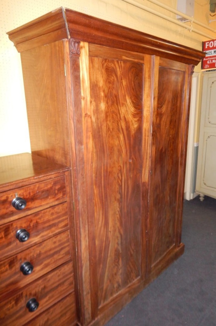 Appraisal: An early Victorian figured mahogany wardrobe the moulded cornice above