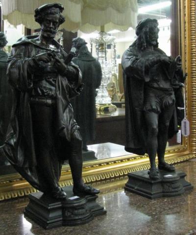 Appraisal: A pair of cast metal figural sculptures bronzed finish one