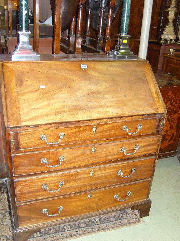 Appraisal: A Georgian mahogany bureau the fall flap enclosing a fitted