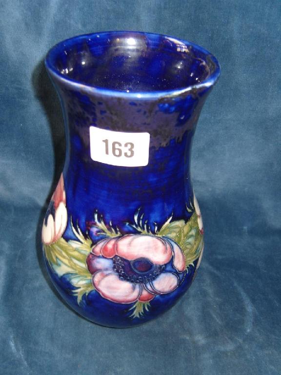 Appraisal: A blue ground Moorcroft vase with pink anemone decoration painted