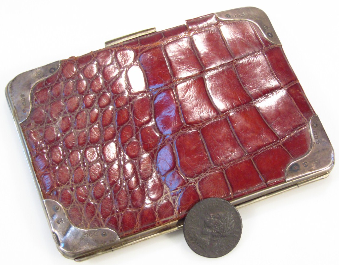 Appraisal: A Victorian silver and crocodile skin purse the rectangular clasp