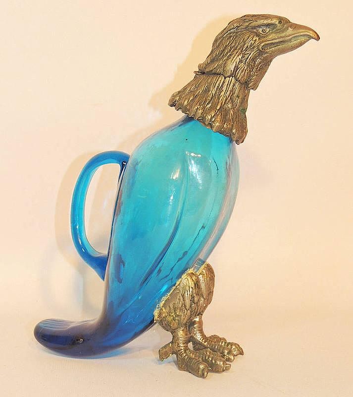 Appraisal: Eagle Form Wine Pitcher With blue glass handled body metal