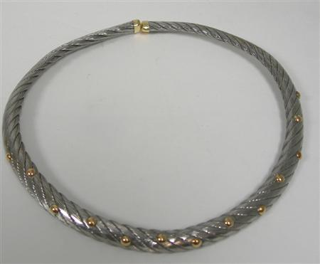 Appraisal: A two-coloured torque form necklace of ropetwisted design applied to