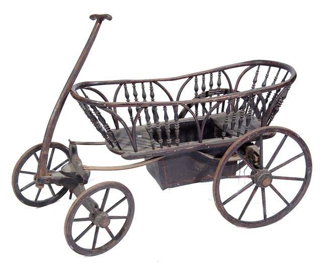 Appraisal: A TH CENTURY CHILD'S HANDCART spindle turned supported frame on