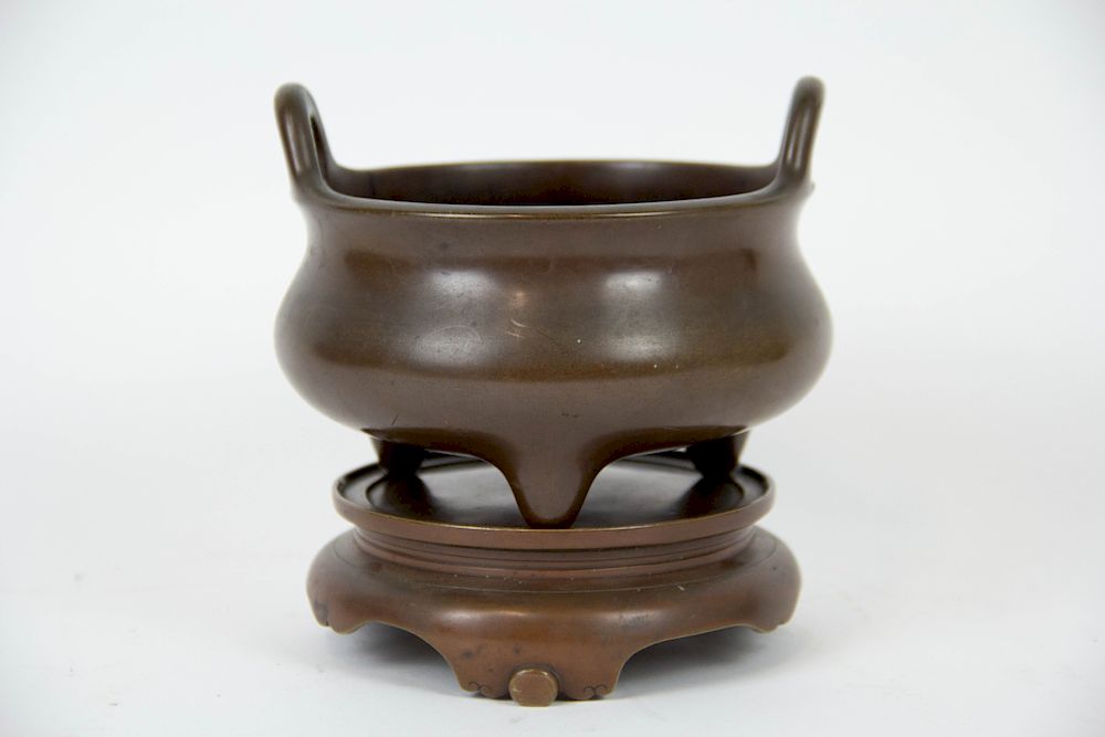 Appraisal: A Bronze Tripod Censer and Stand Qing dynasty With apocryphal