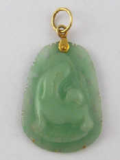 Appraisal: A carved jade pendant with yellow metal tests carat gold