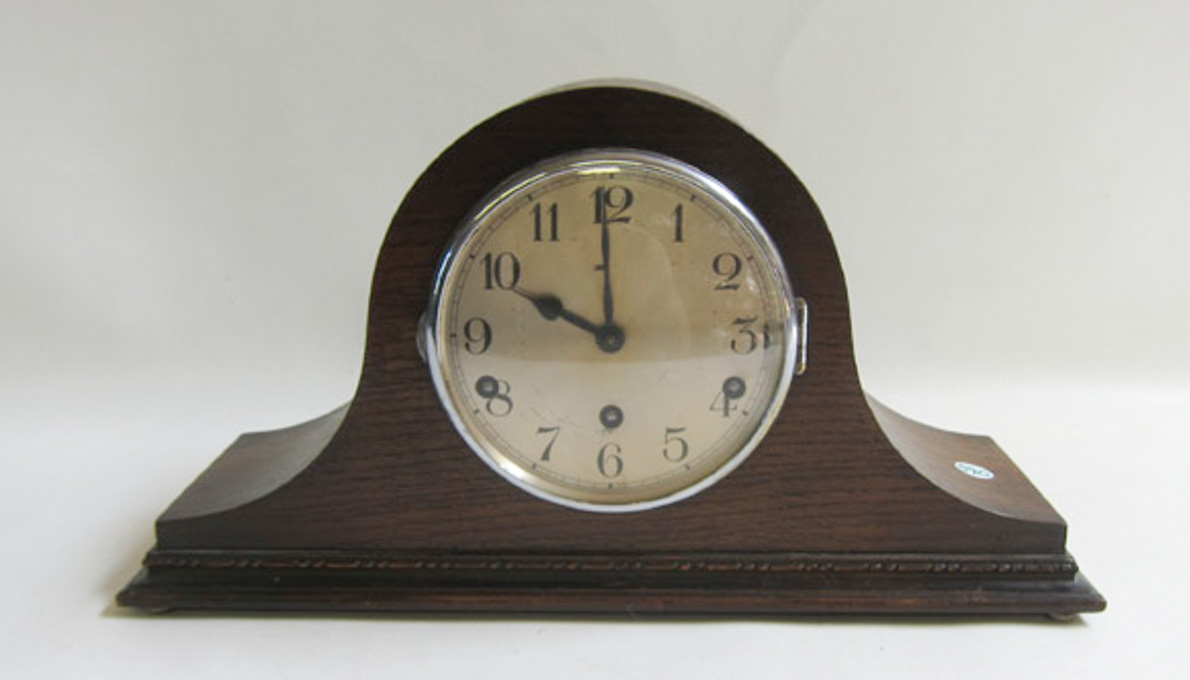 Appraisal: CAMEL BACK VINTAGE MANTLE CLOCK having an oak case with