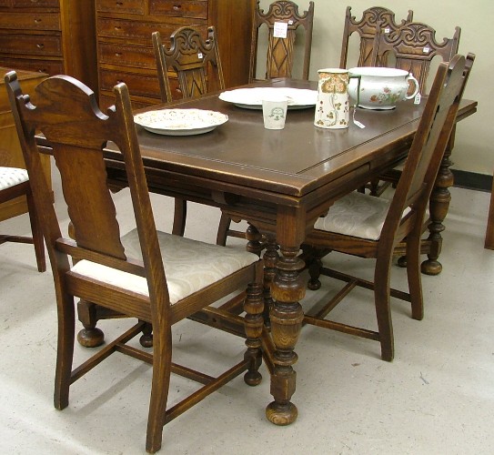 Appraisal: OAK DINING TABLE AND CHAIR SET American c 's including