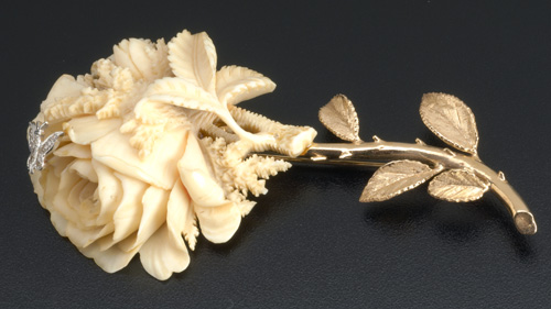 Appraisal: Carved ivory rose brooch with k yg foliage ca with