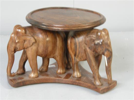 Appraisal: Rosewood stand supported on three elephants on shaped trefoil base