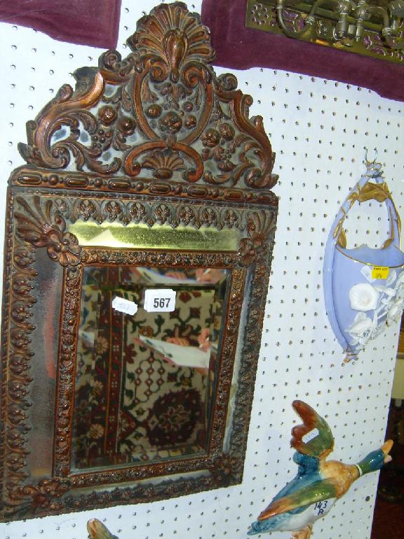 Appraisal: A th century continental bevelled glass mirror with embossed and