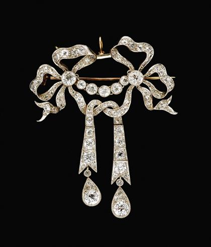 Appraisal: Platinum and diamond bow knot drop brooch belle epoque Delicate