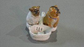 Appraisal: Two Continental porcelain models of seated pugs together with a