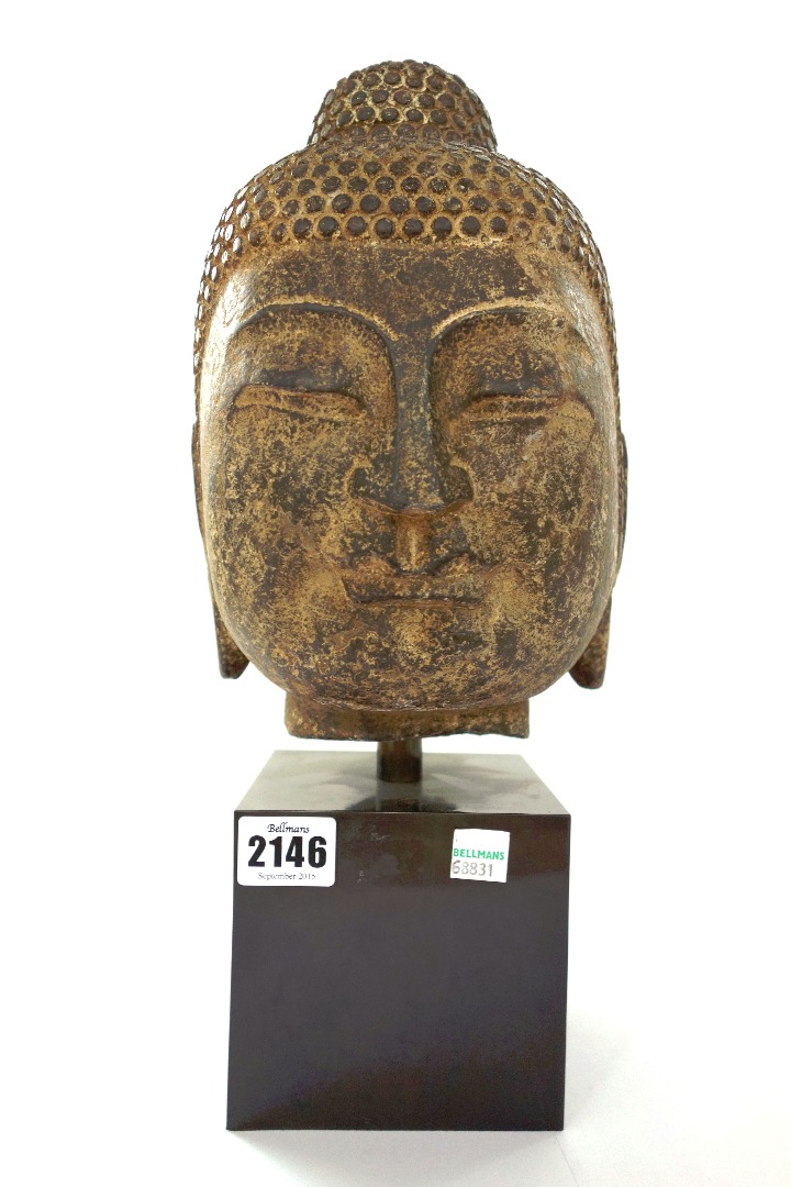 Appraisal: A South East Asian stone figure head mounted on an