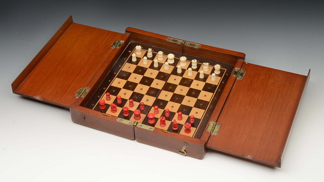 Appraisal: A VICTORIAN MAHOGANY CASED TRAVELLING CHESS SET contained in folding