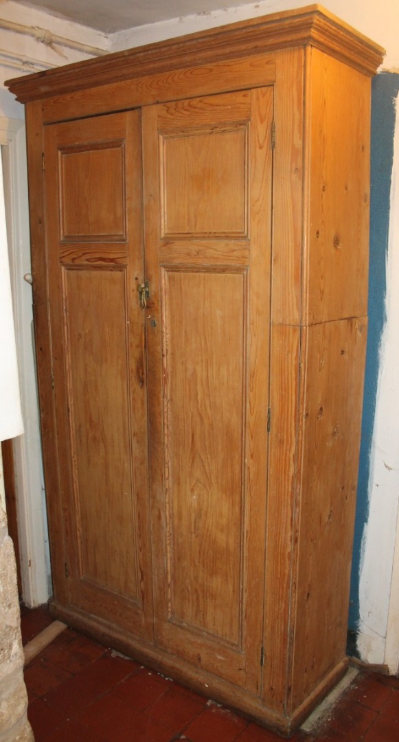 Appraisal: A Victorian stripped pine cupboard with moulded cornice and two