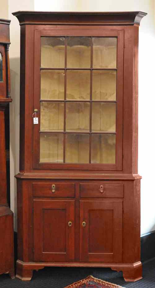 Appraisal: Pennsylvania stained cherry two-piece corner cupboard early th c h