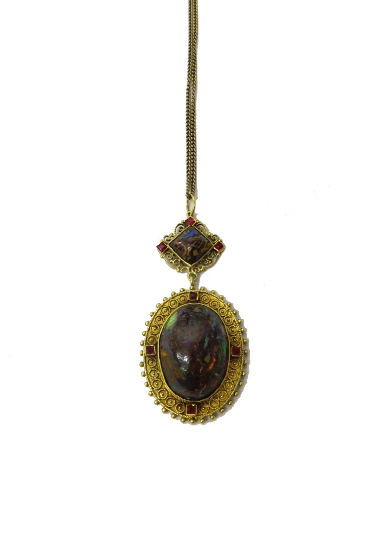 Appraisal: A gilt metal mounted wood opal set pendant the principal