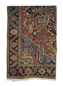 Appraisal: A Heriz carpet the stepped central brick red field on