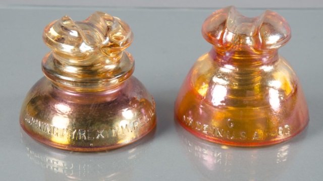 Appraisal: Two Carnival Glass InsulatorsProduced during the 's and 's One