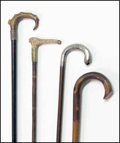 Appraisal: FOUR WALKING STICKS Comprise of one sterling silver cane handle