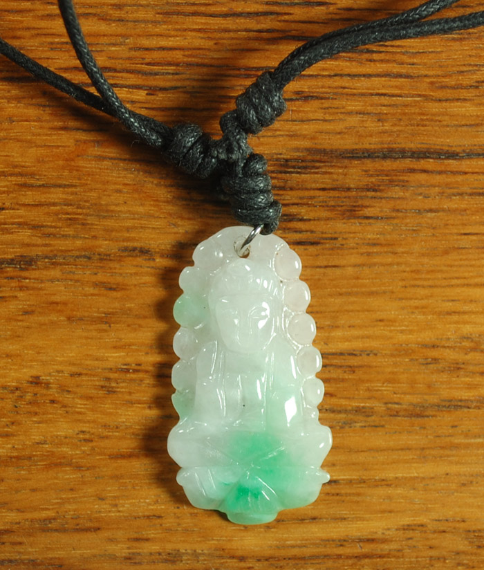 Appraisal: LIGHT GREEN CARVED JADE BUDDHA PENDANT NECKLACE having seated Buddha