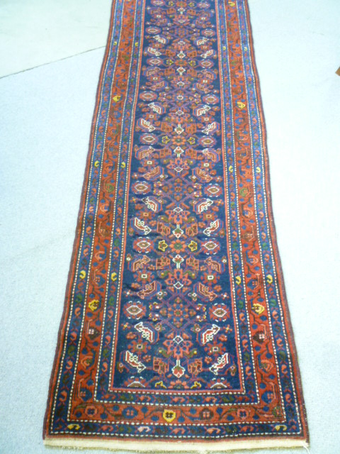 Appraisal: A NORTH WEST PERSIAN HAMADAN RUNNER the navy blue field