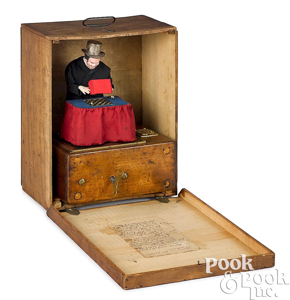 Appraisal: French coin operated magician musical automaton French coin operated magician