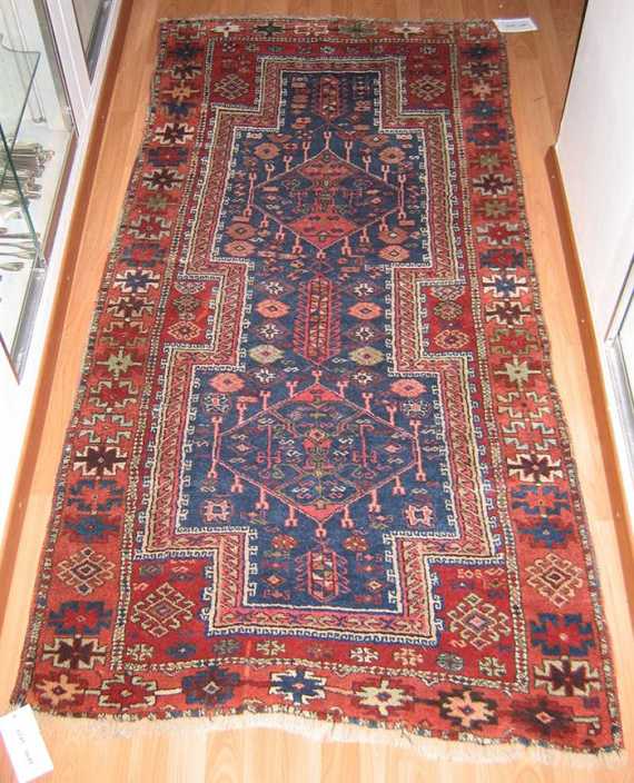 Appraisal: CAUCASIAN old Red central field with a blue central medallion