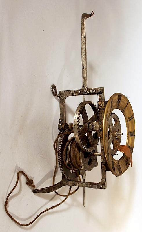 Appraisal: Iron clock movement Iron clock movement with later bronze dial