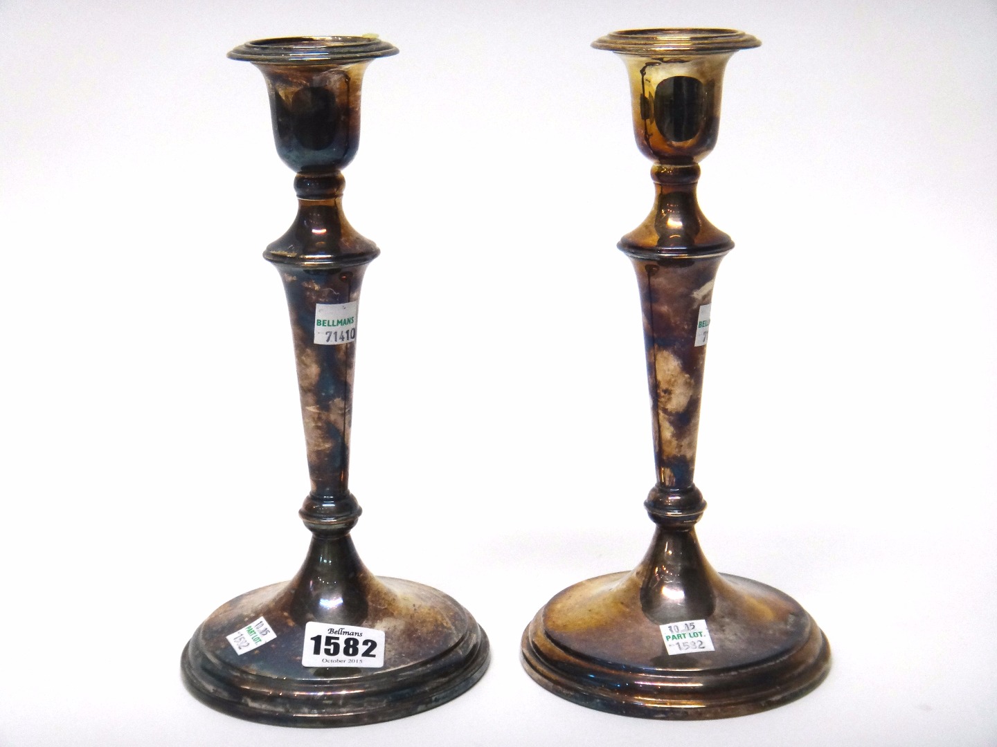 Appraisal: A pair of silver table candlesticks each having a tapered