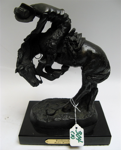 Appraisal: A BRONZE MINIATURE RATTLESNAKE and pewter miniature of cowboy on