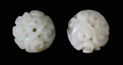 Appraisal: Pair Jade Carved Spheres Chinese th century pale celadon openwork