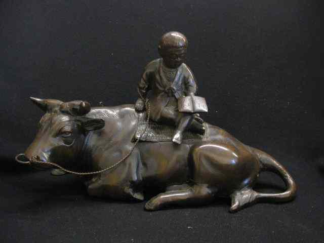 Appraisal: Chinese Bronze Figure of Child Seatedon a resting ox -