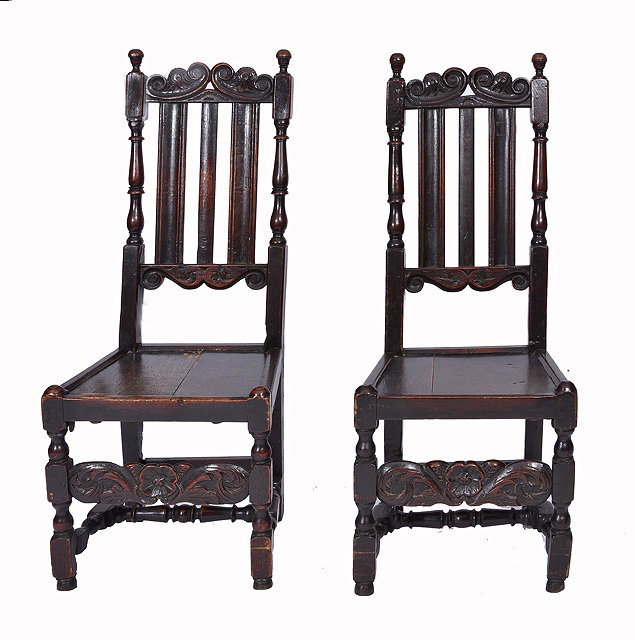 Appraisal: A PAIR OF TH CENTURY OAK HALL CHAIRS with scroll