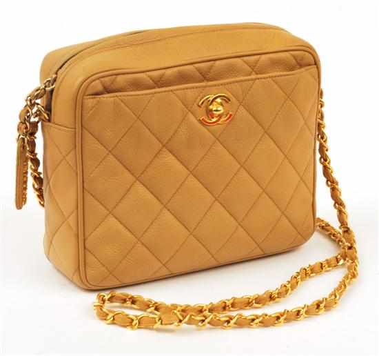 Appraisal: A MINI CAMERA BAG BY CHANEL Styled in quilted beige