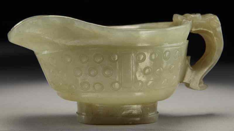 Appraisal: Chinese Ming carved jade yi-shaped libation cupdepicting pebbles with a