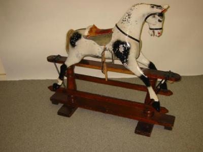 Appraisal: A carved and painted wood rocking horse with inset glass