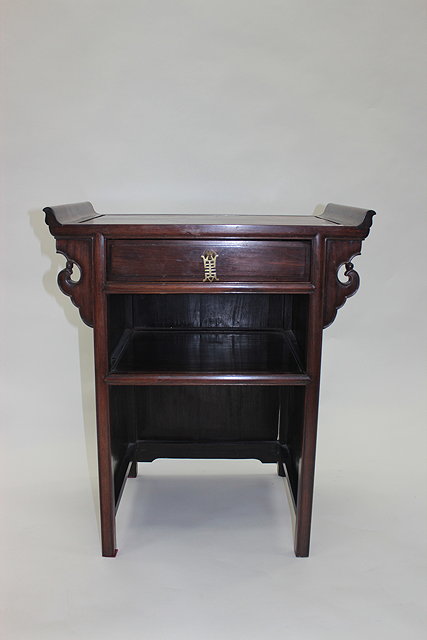 Appraisal: A CHINESE PADOUK WOOD SIDE TABLE the shaped top with