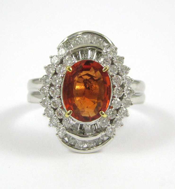 Appraisal: ORANGE SAPPHIRE AND FOURTEEN KARAT GOLD RING The white and