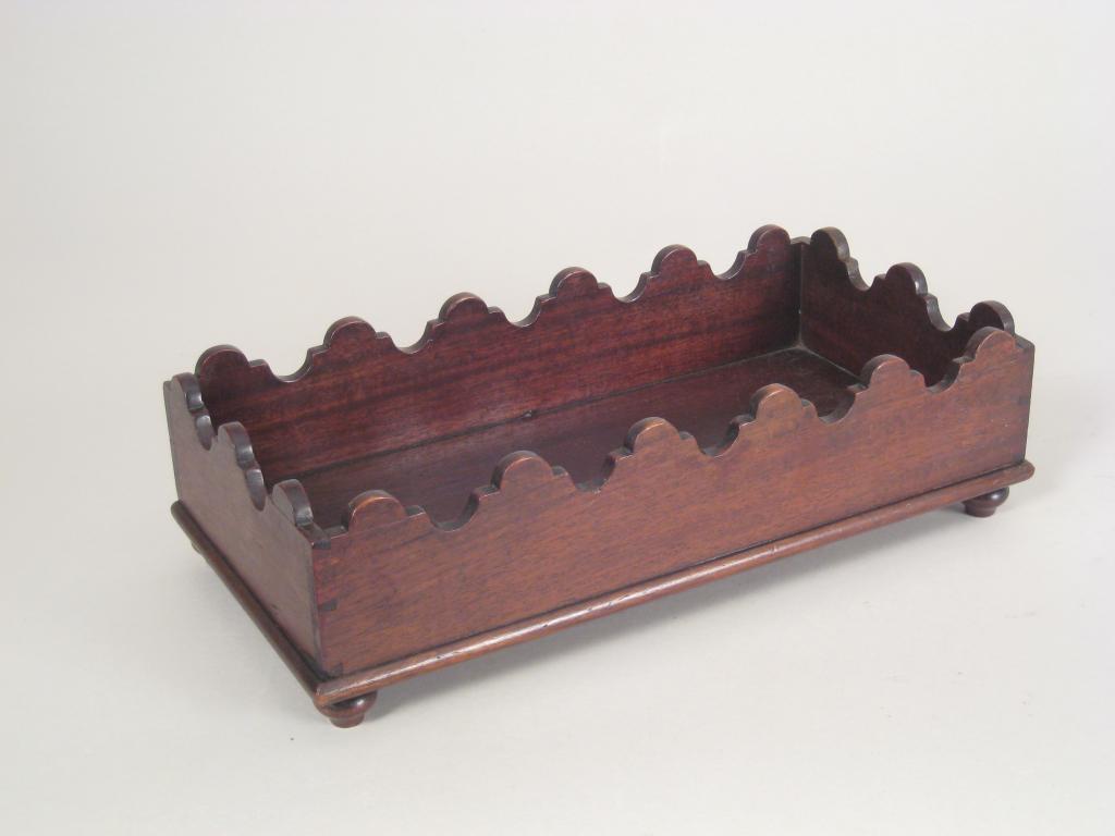 Appraisal: A th Century mahogany oblong Desk Tidy with shaped rim