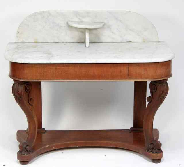 Appraisal: A Victorian washstand the marble top and backsplash on carved