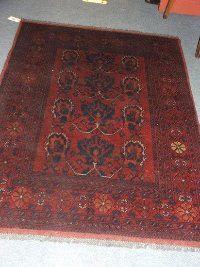 Appraisal: A TURKOMAN RED GROUND MAT - decorated a stylised foliate