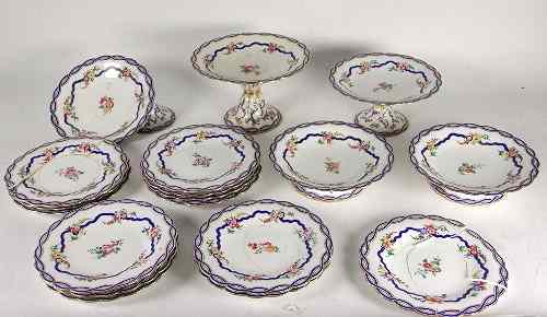 Appraisal: An English porcelain dessert service decorated floral sprays within an