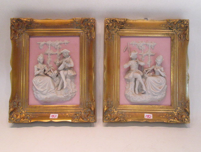 Appraisal: A PAIR OF BISQUE PORCELAIN RELIEF WALL PLAQUES each rectangular