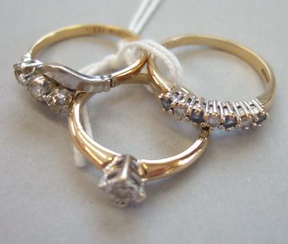 Appraisal: A gold and platinum diamond set three stone ring mounted